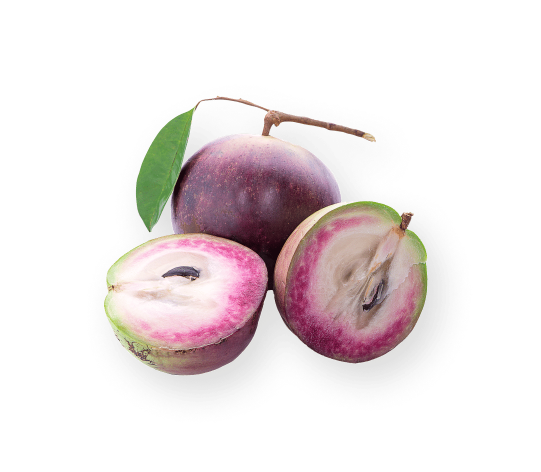 Three star apples, halved and whole, rest on a dark background.